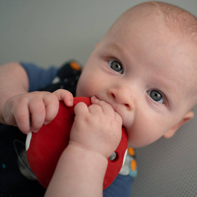 Baby Theo enjoying his Mars Biscuit natural rubber space teether